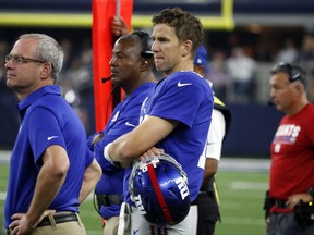 New York Giants quarterback Eli Manning watches play against the Dallas Cowboys in the closing minutes of the second half of an NFL football game, Sunday, Sept. 10, 2017, in Arlington, Texas. (AP Photo/Michael Ainsworth)