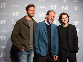 Actor Armie Hammer, left to right, director Luca Guadagnino and actor Timothee Chalamet pose for photos before a press conference for the film "Call Me By Your Name" at the Toronto International Film Festival in Toronto on Friday, September 8, 2017. THE CANADIAN PRESS/Chris Donovan