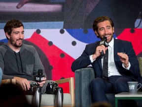 Actor Jake Gyllenhaal, right, speaks alongside Jeff Bauman who he plays in the movie "Stronger" during a press conference at the Toronto International Film Festival in Toronto on Saturday, Sept. 9, 2017. THE CANADIAN PRESS/Chris Donovan