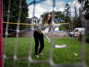 Julia van Damme, 12, who was diagnosed with a low-grade glioma brain tumour after a routine eye exam plays hockey in her backyard in Mississauga, Ont., on Wednesday, September 6, 2017.