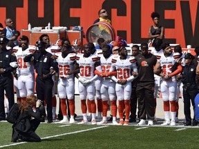 Members of the Cleveland police and the Cleveland Browns players stand together during the national anthem before an NFL football game between the Pittsburgh Steelers and the Cleveland Browns, Sunday, Sept. 10, 2017, in Cleveland. (AP Photo/David Richard)