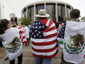 FILE - In this June 26, 2017, file photo, protesters outside the federal courthouse in San Antonio, Texas, take part in a rally to oppose a new Texas "sanctuary cities" bill that aligns with the president's tougher stance on illegal immigration. A federal appeals court gave Texas more latitude Monday, Sept. 25, 2017, to enforce a "sanctuary cities" ban backed by the Trump administration, but opponents suing over the immigration crackdown said it was unlikely to drastically change the status quo. (AP Photo/Eric Gay, File)