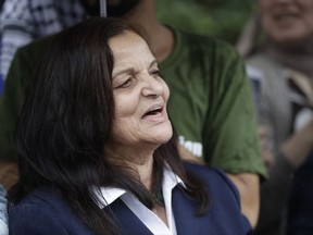 FILE - In this Aug. 17, 2017 file photo, Palestinian activist Rasmea Odeh of Chicago, stands outside the Theodore Levin U.S. Courthouse in Detroit, Mich., for a final court hearing before she's eventually deported. Supporters say the activist is leaving the U.S. for Jordan, after a criminal case that revealed her decades-old record of bombings in Jerusalem. Odeh will leave Chicago's O'Hare International Airport for Jordan on Tuesday Sept. 19, 2017. Supporters plan to gather at the airport's international terminal with signs and banners before she leaves. (AP Photo/Carlos Osorio File)