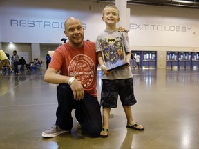 In this Sept. 6, 2017 photo, Michael Howard Hilburn, 42, and his son Michael Evan, 5, pose for photo in the shelter at a convention center in Houston. The father and son were living with a relative in west suburban Katy before the Category 4 hurricane hit along the Gulf Coast on Aug. 26. The elder Hilburn says the twosome have been bouncing around the country homeless for about two years, struggling ever since he lost his job while dealing with a health issue. The Hilburns are now among the 3,000 people staying at a convention center set up as a shelter next to the NRG football stadium in southwest Houston. (AP Photo/Brian Melley)