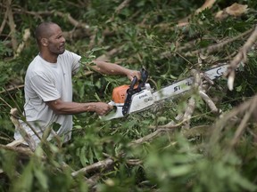 A municipal government worker clears a road after the passing of Hurricane Maria, in Yabucoa, Puerto Rico, Thursday, September 21, 2017. As of Thursday evening, Maria was moving off the northern coast of the Dominican Republic with winds of 120 mph (195 kph). The storm was expected to approach the Turks and Caicos Islands and the Bahamas late Thursday and early Friday. (AP Photo/Carlos Giusti)
