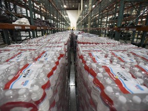 Water bottles sit in a FEMA Central Warehouse as they are organized for delivery to residents after the passage of Hurricane Maria in San Juan, Puerto Rico, Tuesday, Sept. 26, 2017. The federal government announced it will pick up 100 percent of the costs of for debris removal and other emergency assistance provided to Puerto Rico in the wake of Hurricane Maria. (AP Photo/Carlos Giusti)