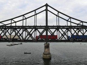 Trucks return over the Friendship Bridge, from the North Korean town of Sinuiju to the Chinese border city of Dandong, in China's northeast Liaoning province on September 5, 2017.