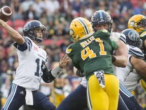 Toronto Argonauts quarterback Ricky Ray, left, looks to make a pass during second half CFL football action against the Edmonton Eskimos in Toronto on Saturday, September 16, 2017. THE CANADIAN PRESS/Chris Young
