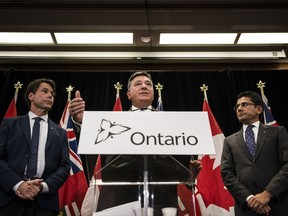 Minister of Finance, Charles Sousa, centre, Attorney General, Yasir Naqvi, right, and Minister of Health and Long-Term Care, Eric Hoskins speak during a press conference where they detailed Ontario's solution for recreational marijuana sales, in Toronto on Friday, September 8, 2017.