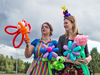 Face painter Ilea Wakelin, left, and balloon artist Lauren Preston at a protest against a proposed balloon ban from city parks and community centres, in Vancouver on Sept. 18, 2017.
