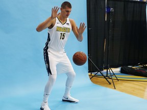 Denver Nuggets center Nikola Jokic hams it up for a photographer during an NBA basketball media day Monday, Sept. 25, 2017, in Denver. The Nuggets open training camp for the upcoming NBA season Tuesday on the campus of the University of Colorado in Boulder, Colo. (AP Photo/David Zalubowski)