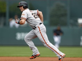 San Francisco Giants' Buster Posey breaks from first base on a ground ball hit by Brandon Crawford off Colorado Rockies starting pitcher Chad Bettis in the first inning of a baseball game Monday, Sept. 4, 2017, in Denver. Posey was forced out at second base on the play. (AP Photo/David Zalubowski)