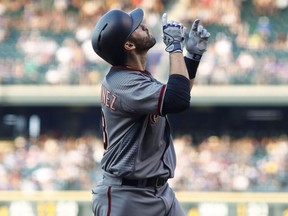 Arizona Diamondbacks' J.D. Martinez crosses home plate after hitting a three-run home run off Colorado Rockies starting pitcher Jon Gray in the first inning of a baseball game Saturday, Sept. 2, 2017, in Denver. (AP Photo/David Zalubowski)