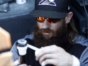 Colorado Rockies center fielder Charlie Blackmon tapes the handle of his bat before a baseball game against the Los Angeles Dodgers, Friday, Sept. 29, 2017, in Denver. (AP Photo/David Zalubowski)