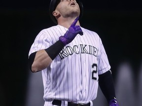 Colorado Rockies' Trevor Story gestures as he crosses home plate after hitting a three-run home run off Miami Marlins starting pitcher Jose Urena in the first inning of a baseball game Tuesday, Sept. 27, 2017, in Denver. (AP Photo/David Zalubowski)