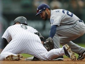 Colorado Rockies' Gerardo Parra, left, slides safely into second base with an RBI-double as San Diego Padres second baseman Carlos Asuaje fields the throw from the outfield in the fourth inning of a baseball game Sunday, Sept. 17, 2017, in Denver. (AP Photo/David Zalubowski)