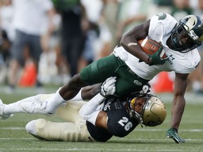Colorado State wide receiver Michael Gallup, top, is dragged down after pulling in a pass by Colorado defensive back Isaiah Oliver in the first half of an NCAA college football game Friday, Sept. 1, 2017, in Denver. (AP Photo/David Zalubowski)