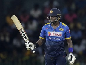 Sri Lanka's Angelo Mathews raises his bat to celebrate scoring fifty runs during their fourth one-day international cricket match against India in Colombo, Sri Lanka, Thursday, Aug. 31, 2017. (AP Photo/Eranga Jayawardena)