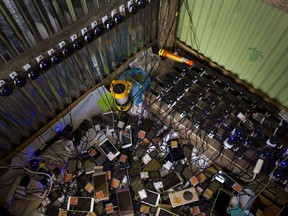 In this Saturday, Sept. 23, 2017 photo, dozens of cellphones charge in a makeshift shop for a price of five taka (US$ 0.06), in Lambashia, near Kutupalong. Local Bangladeshis, worried as they are about the sheer numbers of the newcomer Rohingya Muslims, are finding that within slum life too there are spaces for commerce. Slum lords are charging Rohingya refugee a few thousand takas for space to build a shelter. The most inspired business idea here though belongs to Jalal, a 25-year-old local man who has set up the shop to charge cellphones. With no electricity in the camps his business is booming. (AP Photo/Bernat Armangue)