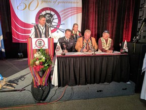RCMP Deputy Commissioner Kevin Brosseau, seated left to right, Manitoba Metis Federation President David Chartrand and Metis National Council President Clement Chartier take part in a signing ceremony at the Manitoba Metis Federation's Annual General Assembly in Winnipeg in this Saturday, Sept. 23, 2017 handout photo. Three items, including a crucifix, that belonged to North-West Rebellion leader Louis Riel and which have been held by the RCMP for decades will soon return to Metis possession. RCMP Deputy Commissioner Kevin Brosseau and Manitoba Metis Federation President David Chartrand signed a memorandum of understanding on Saturday that will see the items transferred to a Metis heritage centre in Winnipeg, once it is built. THE CANADIAN PRESS/HO - RCMP