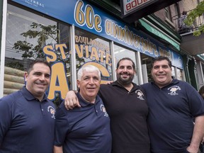 Joe Morena stands in from of his bagel shop with his sons Vince, Robert and Nick, left to right, Sunday, May 21, 2017 in Montreal. St-Viateur bagel celebrated 60 years of bagel-making with a block party in Montreal's Mile End neighbourhood Sunday. THE CANADIAN PRESS/Paul Chiasson