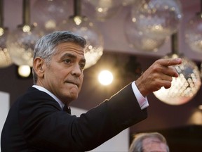 Actor George Clooney arrives on the red carpet of the film "Suburbicon" at the 74th Venice Film Festival in Venice, Italy, Saturday, Sept. 2, 2017. As George Clooney unveils his new film "Suburbicon," about racial tensions in a white southern town in 1950, he says he feels a great sense of frustration and shame that the subject matter is so timely and that the U.S. is in a state of political upheaval. THE CANADIAN PRESS/AP, Domenico Stinellis