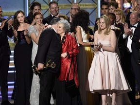 Bruce Miller, from left, Margaret Atwood, and Elisabeth Moss accept the award for outstanding drama series for "The Handmaid's Tale" at the 69th Primetime Emmy Awards in Los Angeles on Sunday, Sept. 17, 2017. The Canadian literary community is celebrating the success of the series "The Handmaid's Tale," which is based on Toronto author Margaret Atwood's 1985 dystopian novel. THE CANADIAN PRESS/AP-Invision, Chris Pizzello