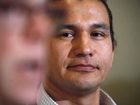 Wab Kinew, right, Manitoba NDP candidate for Fort Rouge, listens as Premier Greg Selinger speaks at a news conference in Winnipeg, Friday, March 11, 2016. Manitoba New Democrats are choosing a replacement for former premier Greg Selinger, who stepped down after the party lost last year's election to the Progressive Conservatives and saw 17 years in power come to an end. THE CANADIAN PRESS/John Woods