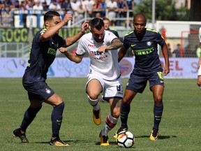 Crotone's Bruno Martella, center, is challenged by Inter MiIan's Joao Mario, right, and Danilo D'Ambrosio, during a Serie A soccer match between Crotone and Inter Milan at the Ezio Scida Stadium in Crotone, Italy, Saturday, Sept. 16, 2017. (Albano Angilletta/ANSA via AP)