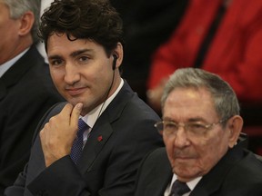 Canada's Prime Minister Justin Trudeau, center, sits with Cuba's President Raul Castro at Havana University in Havana, Cuba.