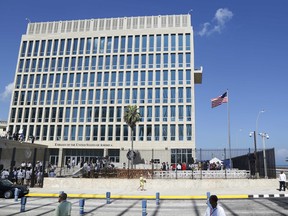 In this Aug. 14, 2015, file photo, a U.S. flag flies at the U.S. embassy in Havana, Cuba. U.S. investigators are chasing many theories about what’s harming American diplomats in Cuba, including a sonic attack, electromagnetic weapon or flawed spying device.