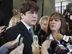 FILE - In this Dec. 7, 2011 file photo, former Illinois Gov. Rod Blagojevich, left, speaks to reporters as his wife, Patti, listens at the federal building in Chicago. Blagojevich said he now spends his time sweeping and mopping floors while serving a federal prison sentence after corruption convictions. Blagojevich said in an interview released Monday, Sept. 11, 2017, from a Colorado prison, that he still maintains his innocence and hopes to make another appeal to the U.S. Supreme Court. The 60-year-old is 5 ½ years into a 14-year sentence. (AP Photo/M. Spencer Green, File)