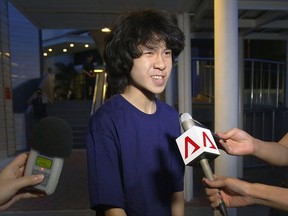 FILE - In this May, 12, 2015, file photo, Singapore teen blogger Amos Yee speaks to reporters in Singapore. A federal immigration appeals court has sided with a Chicago immigration judge's decision to grant asylum to the teenage blogger from Singapore. Attorneys for Amos Yee said Tuesday Sept. 26, 2017, they'd received a Board of Immigration Appeals decision agreeing that the 18-year-old had fear of being persecuted upon return to Singapore.(AP Photo/Wong Maye-E, File)