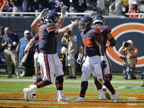 Chicago Bears quarterback Mike Glennon (8) celebrates a touchdown with running back Jordan Howard (24) during the first half of an NFL football game against the Pittsburgh Steelers, Sunday, Sept. 24, 2017, in Chicago. (AP Photo/Charles Rex Arbogast)