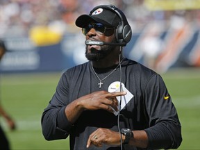 Pittsburgh Steelers head coach Mike Tomlin talks on his headset during the first half of an NFL football game against the Chicago Bears, Sunday, Sept. 24, 2017, in Chicago. (AP Photo/Charles Rex Arbogast)