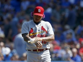 St. Louis Cardinals starting pitcher Carlos Martinez uses the rosin bag prior to the first inning of a baseball game against the Chicago Cubs, Friday, Sept. 15, 2017, in Chicago. (AP Photo/Charles Rex Arbogast)