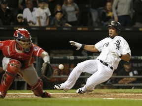 Chicago White Sox's Jose Abreu, right, scores past Los Angeles Angels catcher Martin Maldonado off a double by Nicky Delmonico during the fourth inning of a baseball game Wednesday, Sept. 27, 2017, in Chicago. (AP Photo/Charles Rex Arbogast)