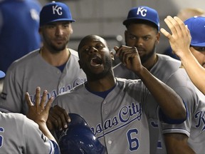 Kansas City Royals' Lorenzo Cain (6) is greeted by his teammates after scoring against the Chicago White Sox during the third inning of a baseball game, Friday, Sept. 22, 2017, in Chicago. (AP Photo/David Banks)