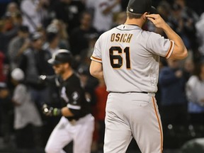 San Francisco Giants relief pitcher Josh Osich (61) reacts after Chicago White Sox's Nicky Delmonico hit a two-run home run during the seventh inning of a baseball game in Chicago, Saturday, Sept. 9, 2017. (AP Photo/Matt Marton)