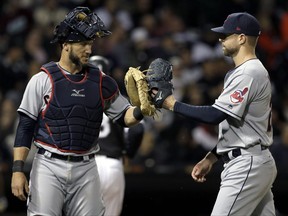 Cleveland Indians starting pitcher Corey Kluber, right, celebrates with catcher Yan Gomes as they walk to the dugout after the sixth inning of a baseball game against the Chicago White Sox, Thursday, Sept. 7, 2017, in Chicago. (AP Photo/Nam Y. Huh)