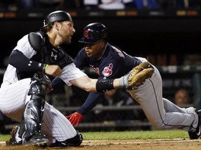 Cleveland Indians' Jose Ramirez, right, scores against Chicago White Sox catcher Kevan Smith during the ninth inning of a baseball game Wednesday, Sept. 6, 2017, in Chicago. The Indians won 5-1. (AP Photo/Nam Y. Huh)
