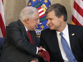 Attorney General Jeff Sessions shakes hands with Christopher Wray during a installation ceremony for Wray as the new FBI director at the FBI Building, Thursday, Sept. 28, 2017, in Washington. (AP Photo/Andrew Harnik)