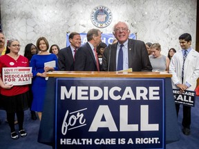 Sen. Bernie Sanders, I-Vt., is joined by Democratic Senators and supporters as he arrives for a news conference on Capitol Hill in Washington, Wednesday, Sept. 13, 2017, to unveil their Medicare for All legislation to reform health care. (AP Photo/Andrew Harnik)