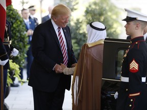 President Donald Trump greets the Amir of Kuwait Sheikh Sabah Al Ahmad Al Sabah as he arrives at the White House in Washington, Thursday, Sept. 7, 2017. (AP Photo/Carolyn Kaster)