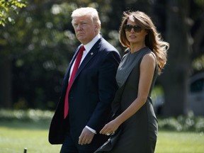 President Donald Trump walks with first lady Melania Trump to board Marine One on the South Lawn of the White House, Friday, Sept. 8, 2017, in Washington. (AP Photo/Evan Vucci)