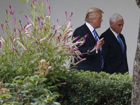 President Donald Trump walks with Vice President Mike Pence after a meeting with Congressional leaders in the Oval Office of the White House, Wednesday, Sept. 6, 2017, in Washington. (AP Photo/Evan Vucci)