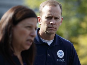 FEMA administrator Brock Long, right, looks on acting Secretary of Homeland Security Elaine Duke speaks to reporters about hurricane recovery efforts in Puerto Rico, outside the White House, Tuesday, Sept. 26, 2017, in Washington. (AP Photo/Evan Vucci)