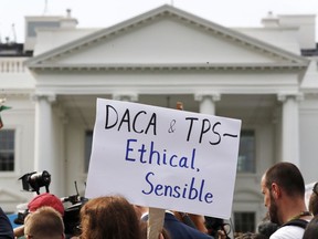 A person holds up a sign in support of the Deferred Action for Childhood Arrivals, known as DACA, and Temporary Protected Status programs during a rally in support of DACA and TPS outside of the White House, in Washington, Tuesday, Sept. 5, 2017. President Donald Trump's administration will "wind down" a program protecting hundreds of thousands of young immigrants who were brought into the country illegally as children, Attorney General Jeff Sessions declared Tuesday, calling the Obama administration's program "an unconstitutional exercise of authority."  (AP Photo/Jacquelyn Martin)