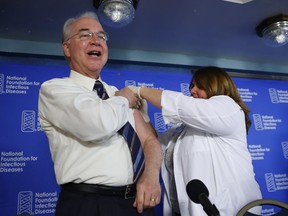 Health and Human Services Secretary Tom Price, left, receives a flu vaccination from Sharon Walsh-Bonadies, RN., right during a news conference recommending everyone age six months an older be vaccinated against influenza each year, Thursday, Sept. 28, 2017 in Washington. (AP Photo/Pablo Martinez Monsivais)