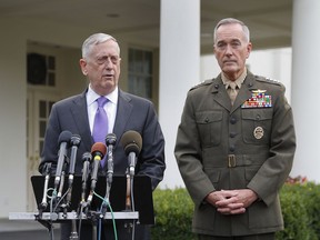 Defense Secretary Jim Mattis, left, accompanied by Joint Chiefs Chairman Gen. Joseph Dunford, right, speaks to members of the media outside the West Wing of the White House in Washington, Sunday, Sept. 3, 2017, regarding the escalating crisis in North Korea's nuclear threats. (AP Photo/Pablo Martinez Monsivais)